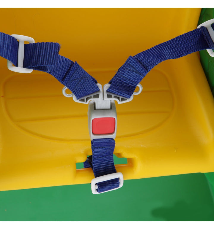 Close-up of a blue safety harness with a red button on a yellow and green background